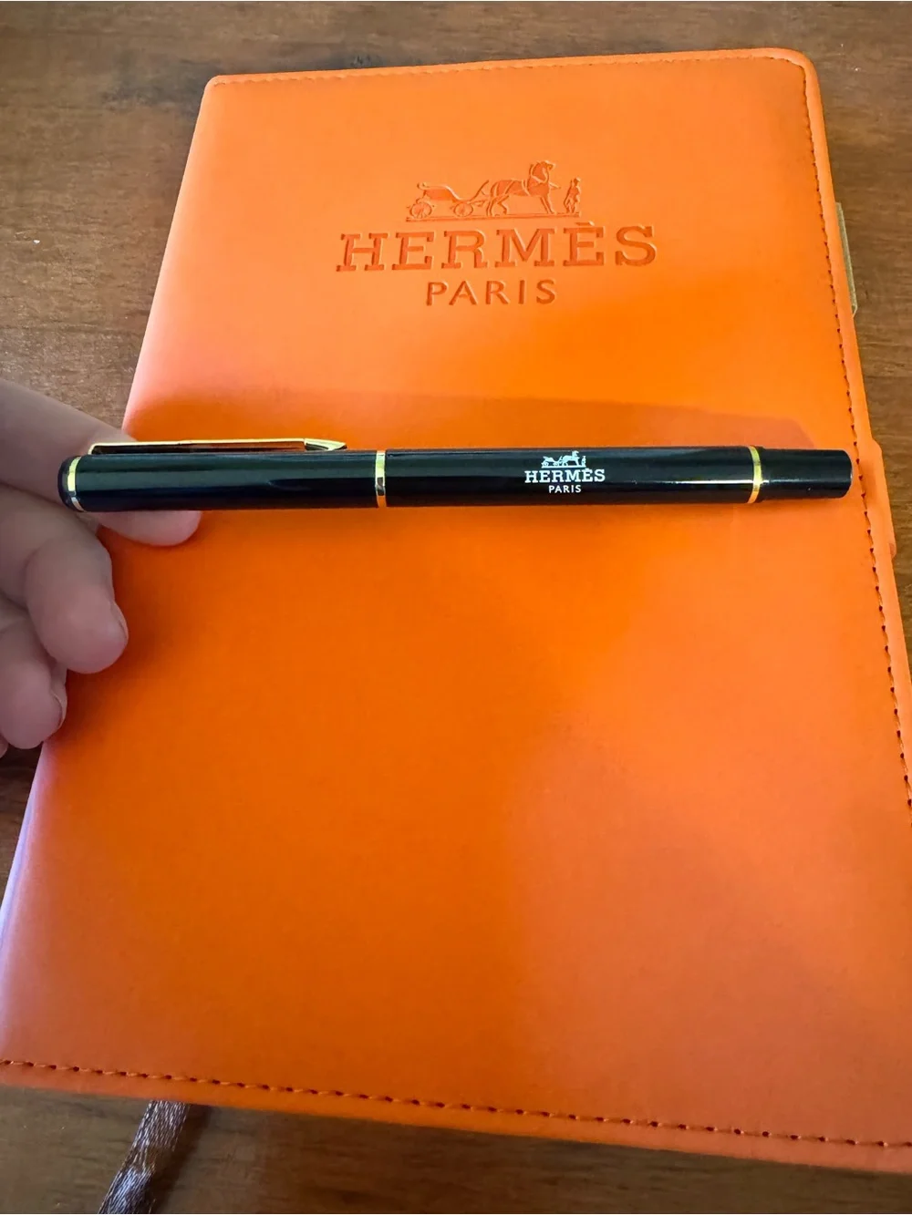 Hermès Daily Planner Journal With pen and paper.